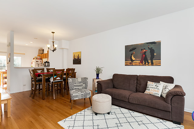 5226 South Berkeley Avenue Chicago, IL 60615 - Photo 2 of 28 a living room with furniture a dining table and a chandelier