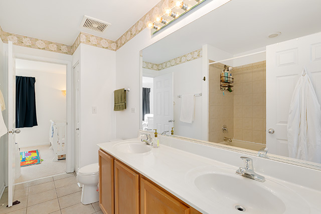5226 South Berkeley Avenue Chicago, IL 60615 - Photo 16 of 28 a bathroom with a sink a toilet a mirror and shower