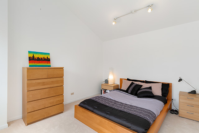 5226 South Berkeley Avenue Chicago, IL 60615 - Photo 17 of 28 a bedroom with a bed and a dresser