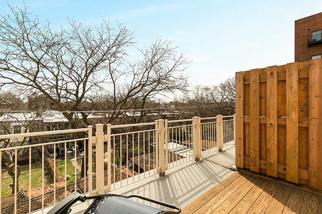 5226 South Berkeley Avenue Chicago, IL 60615 - Photo 26 of 28 a view of a balcony with wooden floor and fence and floor
