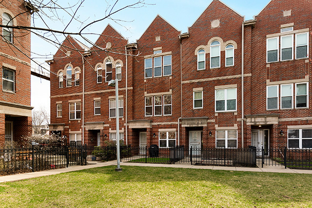 5226 South Berkeley Avenue Chicago, IL 60615 - Photo 27 of 28 a front view of a building with glass windows and a yard