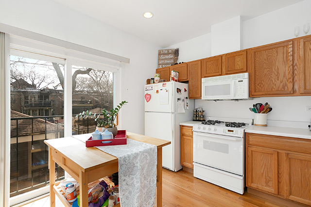 5226 South Berkeley Avenue Chicago, IL 60615 - Photo 7 of 28 a kitchen with a stove a refrigerator and a stove top oven