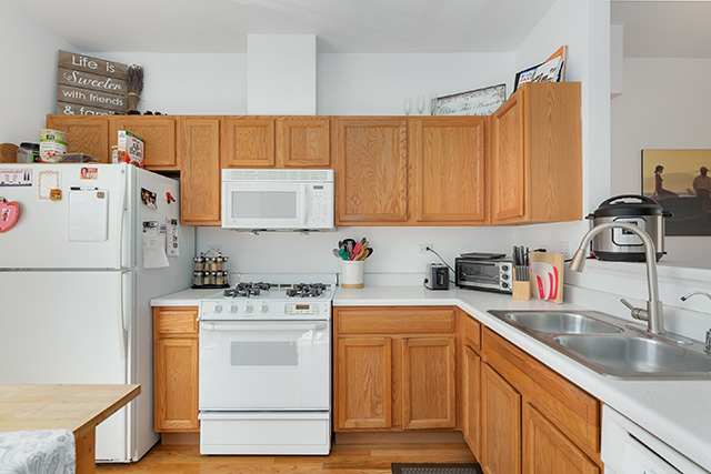 5226 South Berkeley Avenue Chicago, IL 60615 - Photo 8 of 28 a kitchen with a white stove top oven sink and cabinets