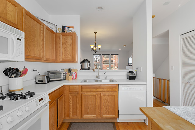 5226 South Berkeley Avenue Chicago, IL 60615 - Photo 9 of 28 a kitchen with a sink a stove and cabinets
