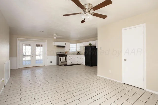 a view of a livingroom with furniture cabinet and windows