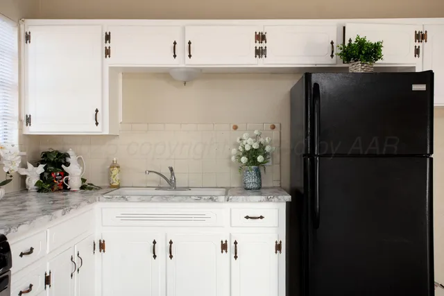 a stove top oven sitting inside of a kitchen