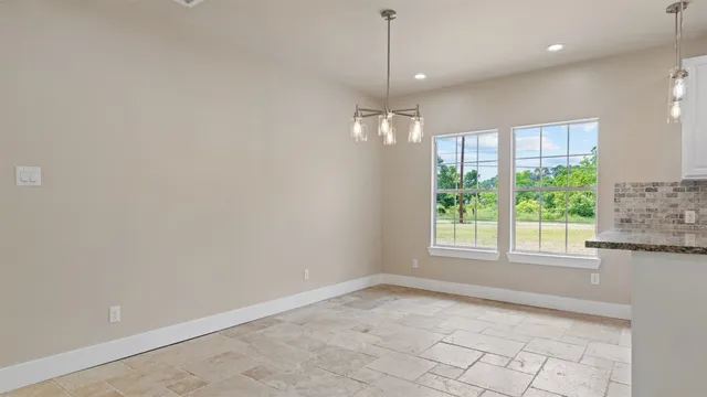 a view of a kitchen with a sink and chandelier fan