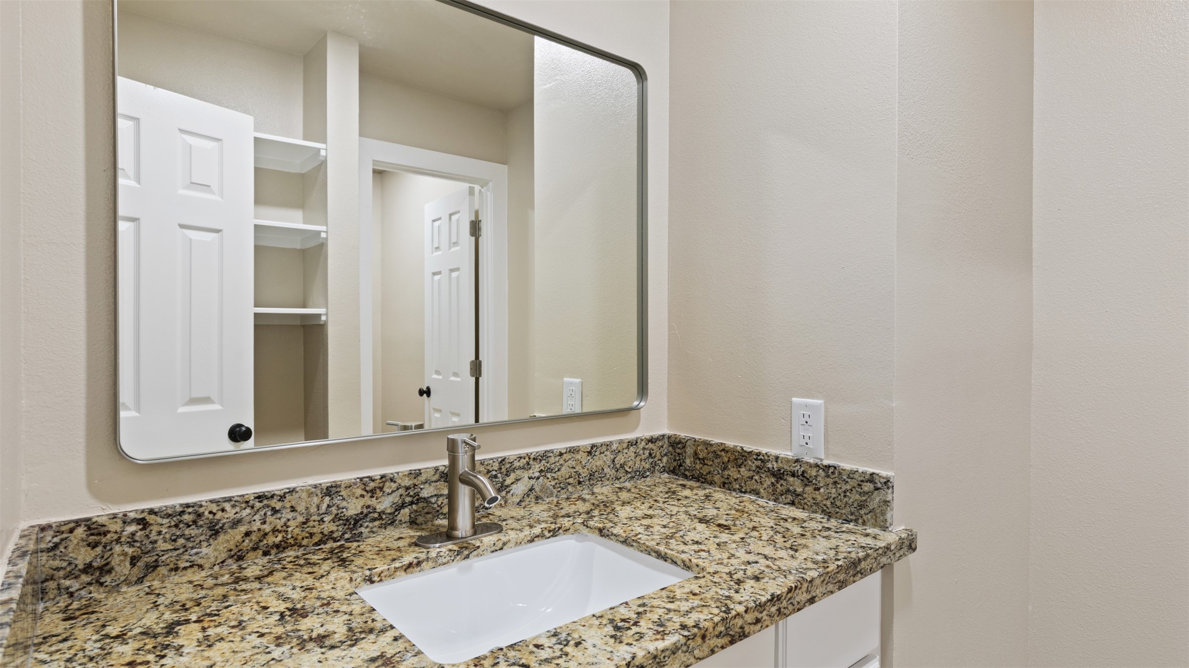 10308 Ehlers Road Conroe, TX 77302 - Photo 28 of 33 a bathroom with a granite countertop sink and a mirror