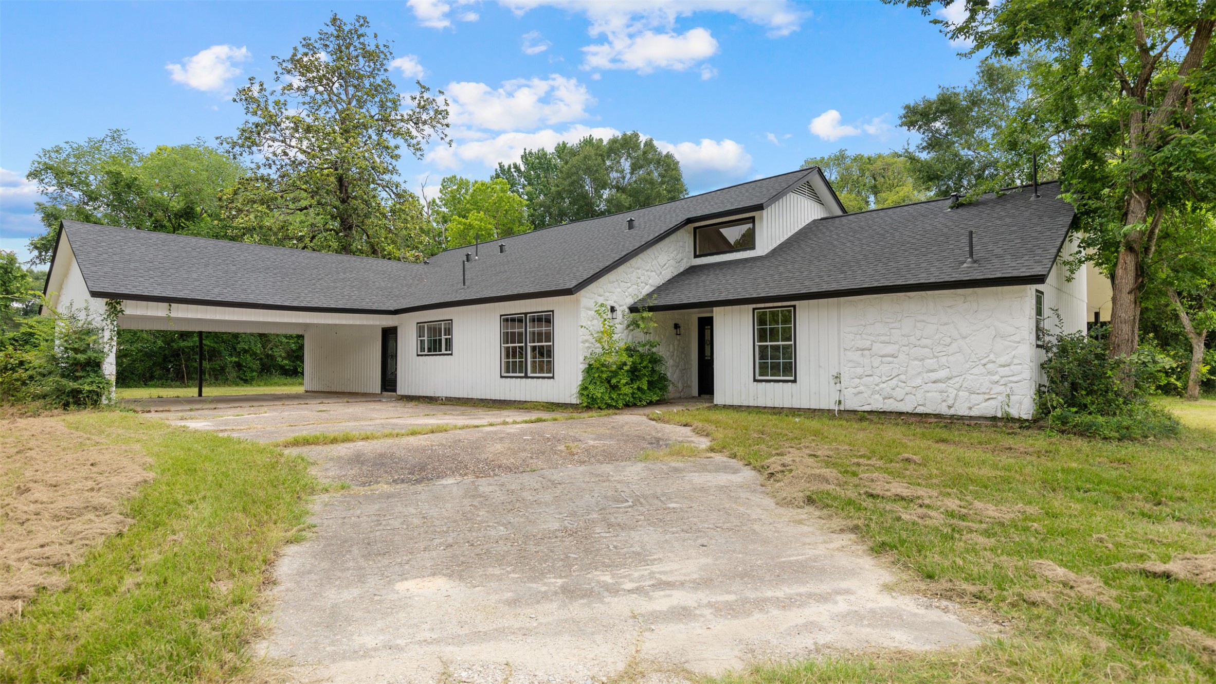 10308 Ehlers Road Conroe, TX 77302 - Photo 29 of 33 a front view of a house with a garden and trees