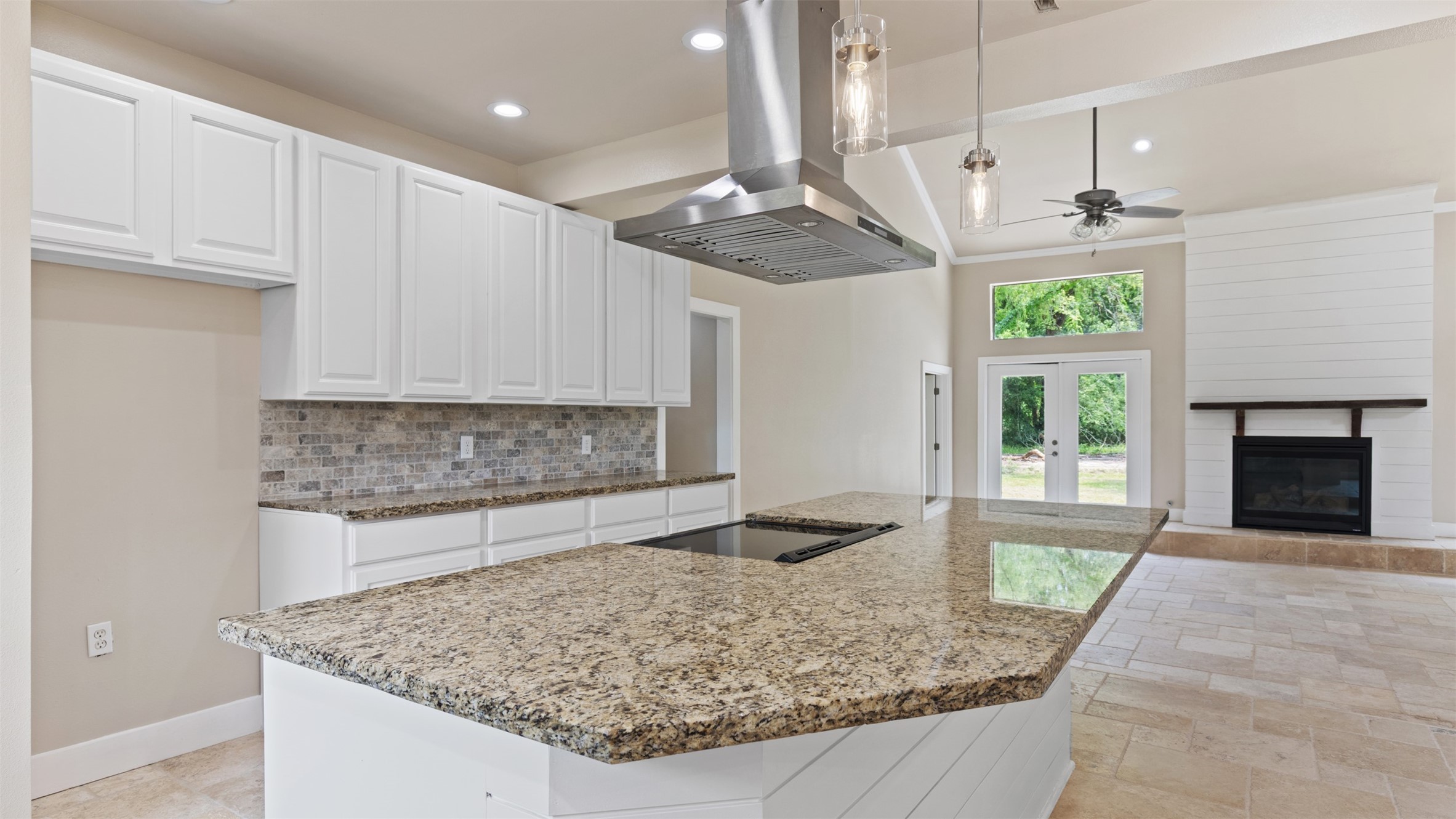 10308 Ehlers Road Conroe, TX 77302 - Photo 8 of 33 a kitchen with kitchen island granite countertop a counter space windows and a fireplace