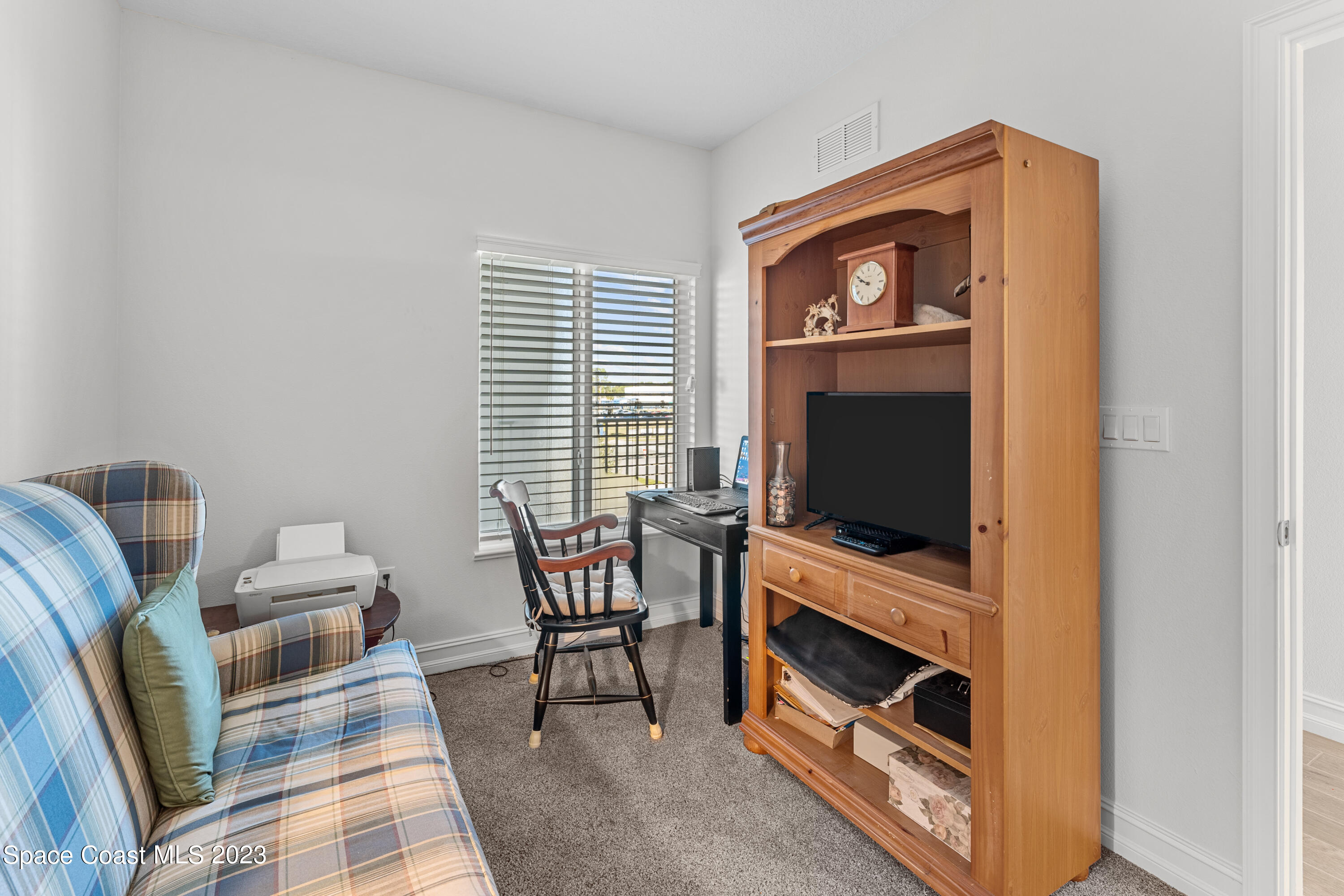 1825 Riverside Drive, Unit 305S Titusville, FL 32780 - Photo 11 of 34 a living room with furniture and a flat screen tv