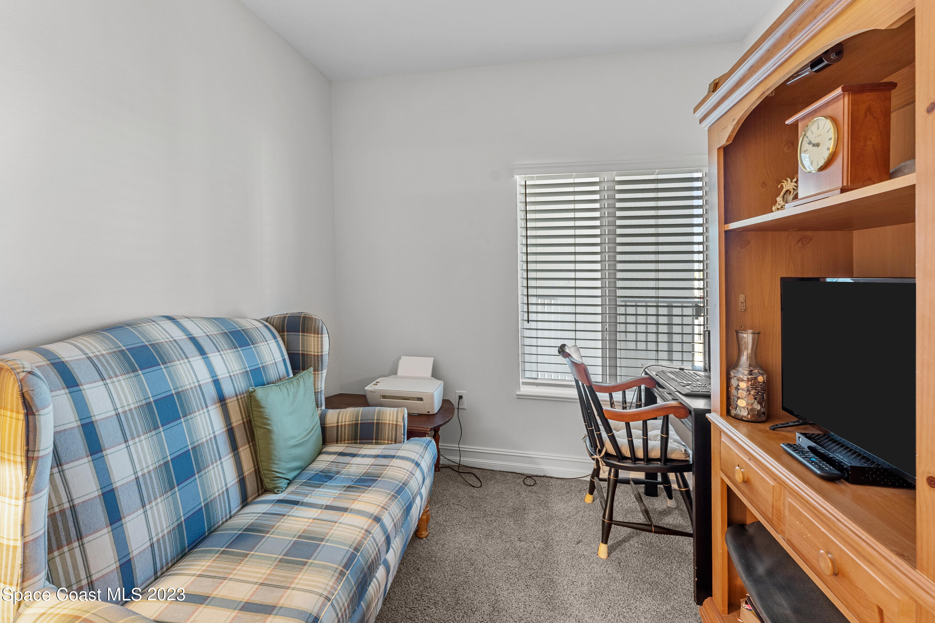 1825 Riverside Drive, Unit 305S Titusville, FL 32780 - Photo 13 of 34 a living room with furniture and a flat screen tv