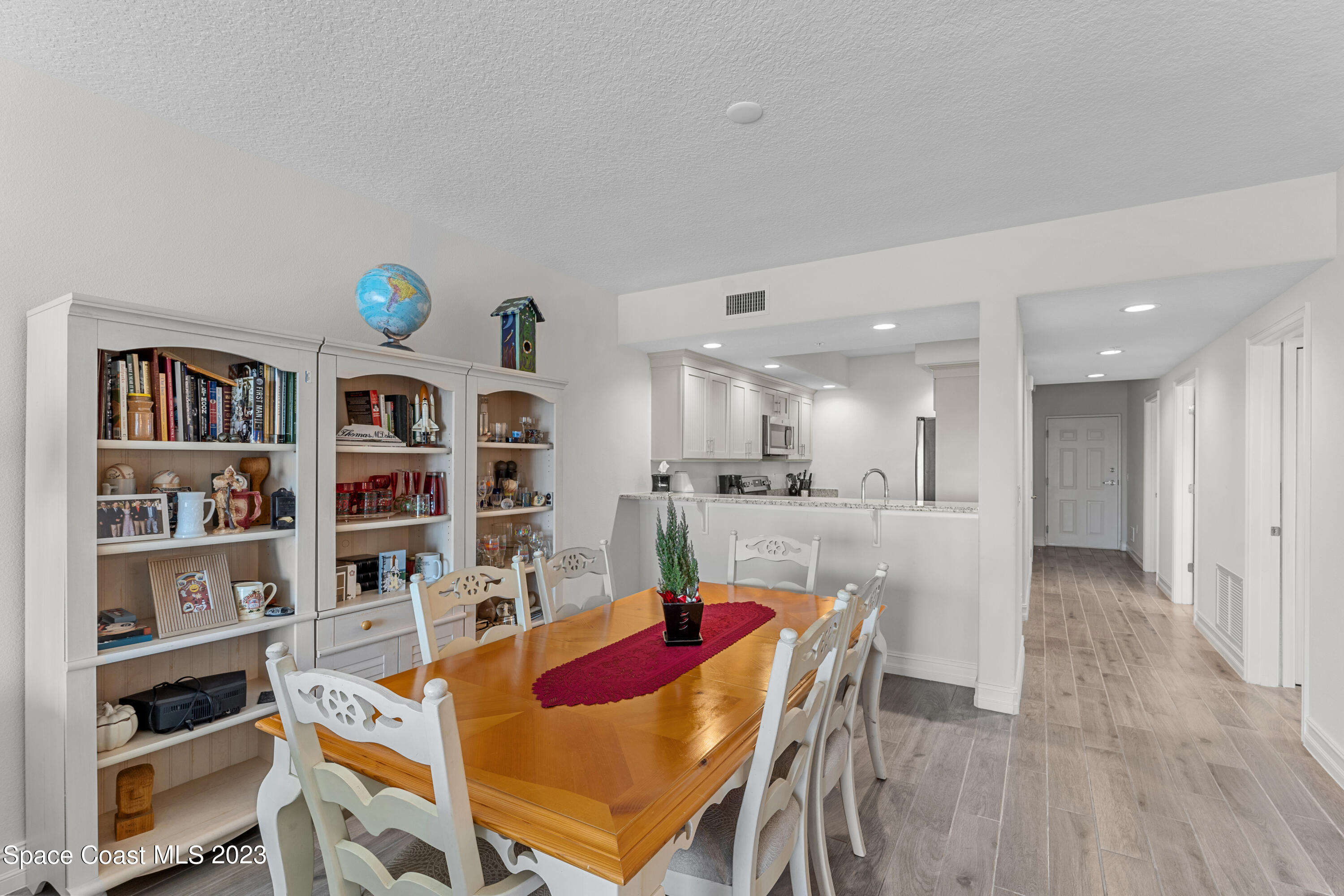 1825 Riverside Drive, Unit 305S Titusville, FL 32780 - Photo 21 of 34 a living room with stainless steel appliances furniture a rug and a book shelf