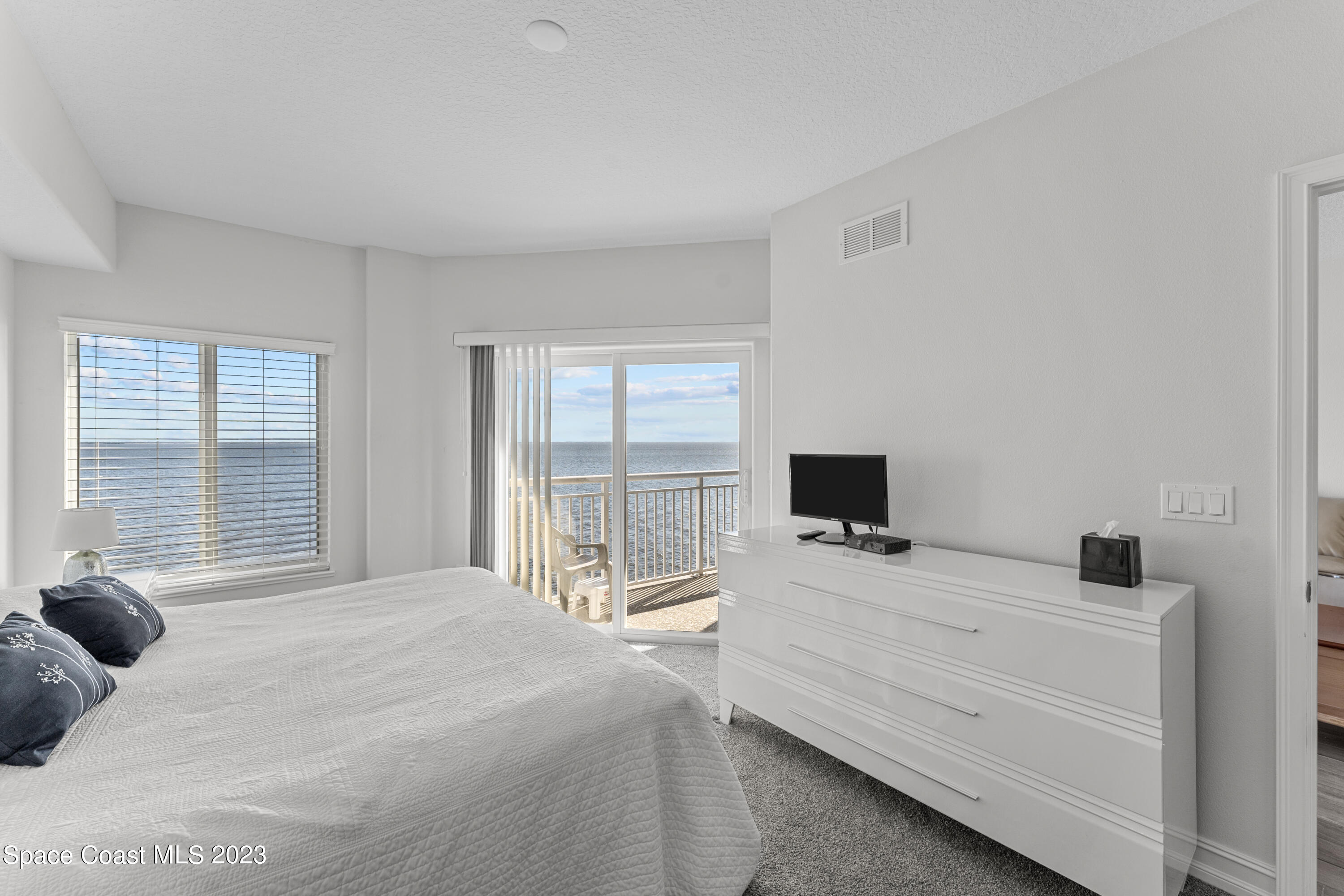 1825 Riverside Drive, Unit 305S Titusville, FL 32780 - Photo 24 of 34 a bedroom with a bed and glass window