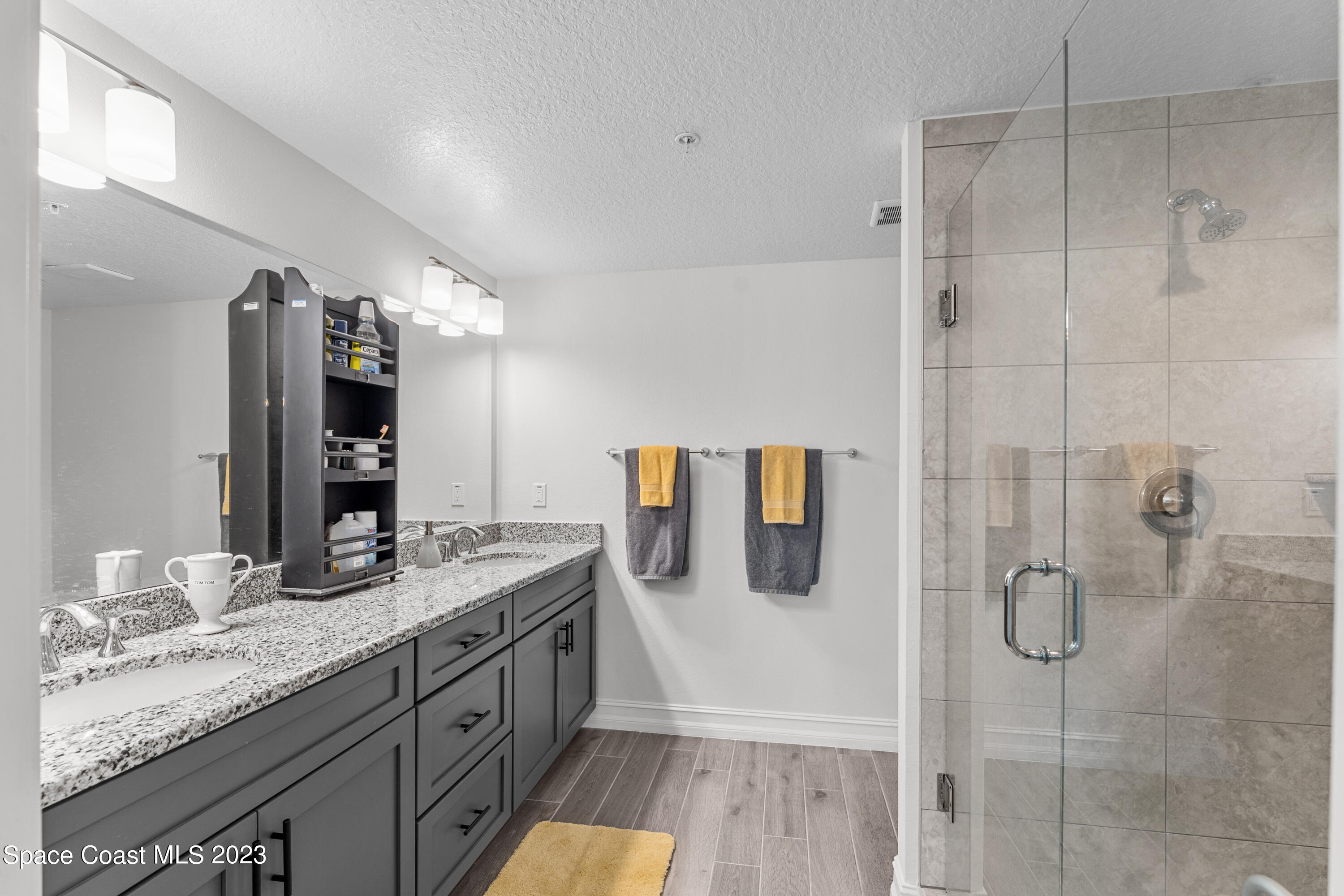 1825 Riverside Drive, Unit 305S Titusville, FL 32780 - Photo 25 of 34 a bathroom with a granite countertop double vanity sink and mirror