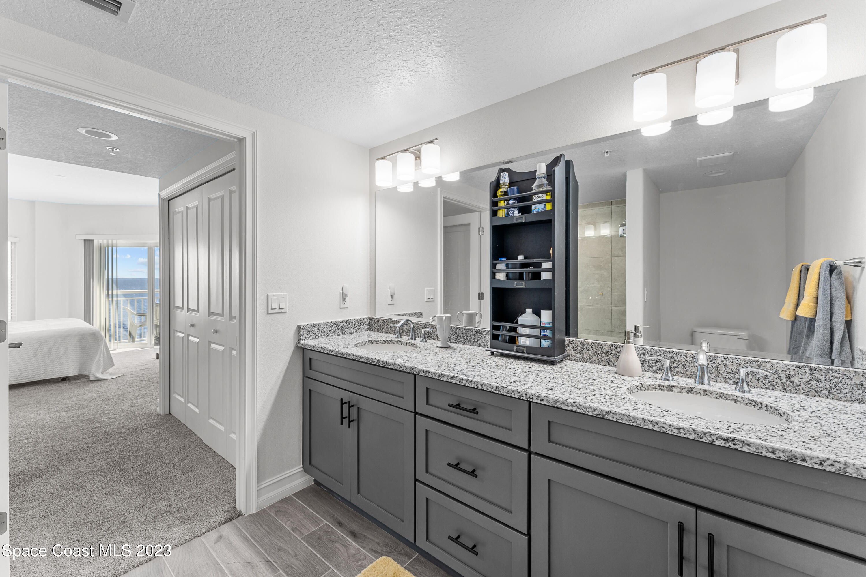 1825 Riverside Drive, Unit 305S Titusville, FL 32780 - Photo 27 of 34 a bathroom with a granite countertop double vanity sink and mirror