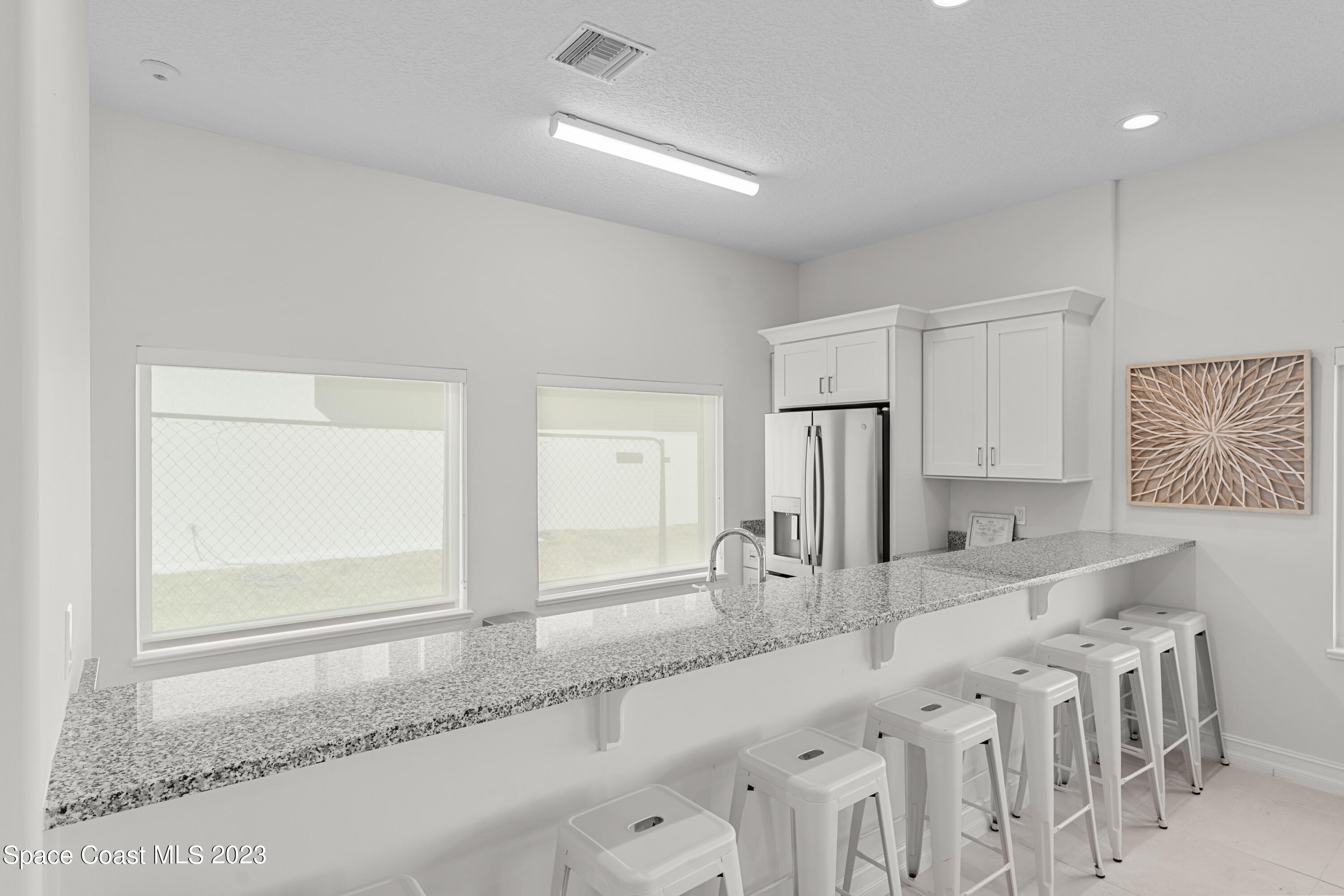 1825 Riverside Drive, Unit 305S Titusville, FL 32780 - Photo 31 of 34 a kitchen with stainless steel appliances granite countertop a sink and a refrigerator
