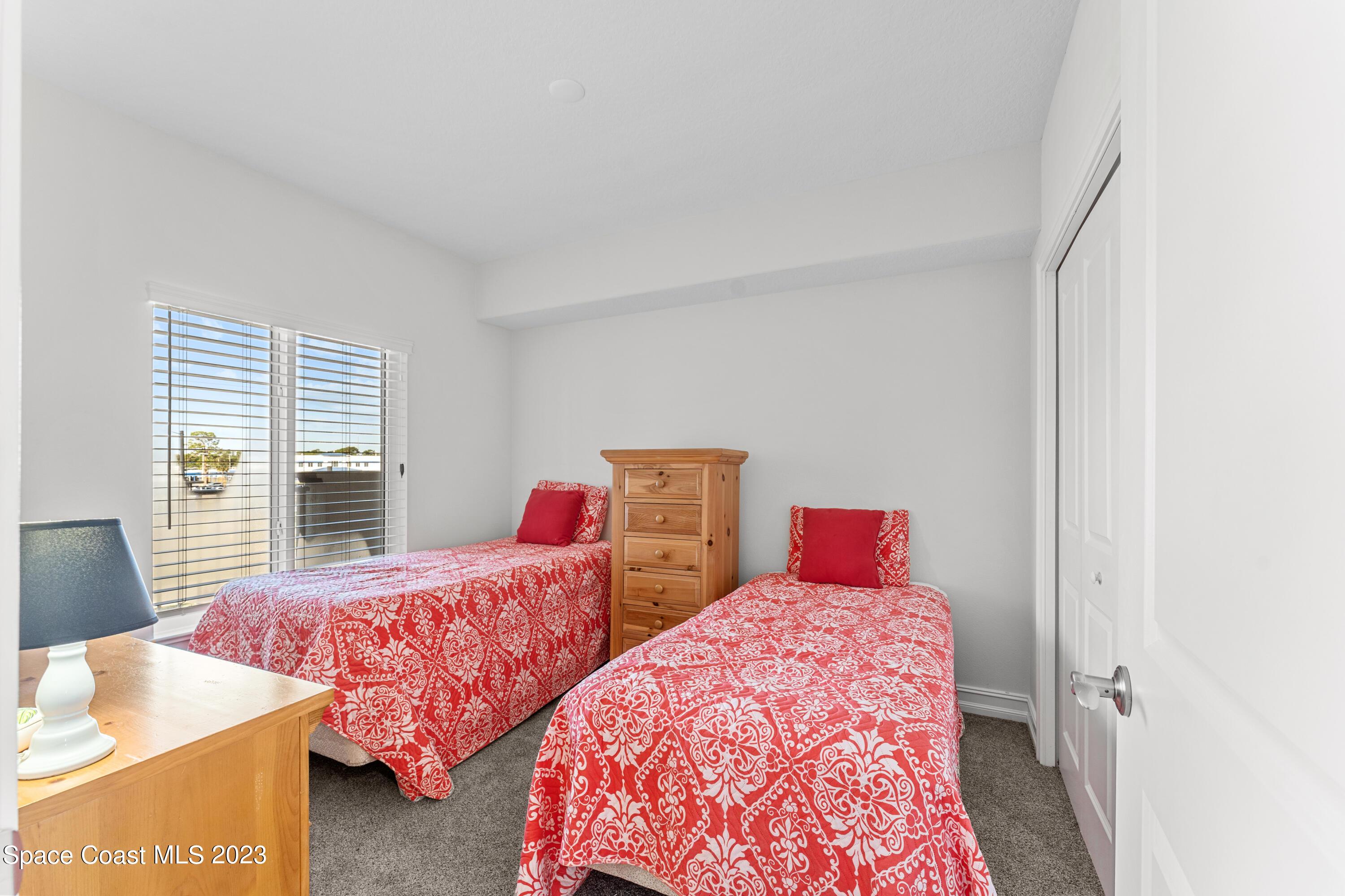 1825 Riverside Drive, Unit 305S Titusville, FL 32780 - Photo 9 of 34 a bedroom with two beds and a window