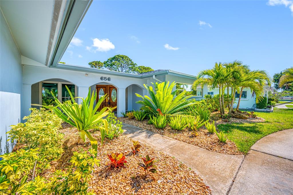 656 Mehlenbacher Road Belleair, FL 33756 - Photo 3 of 49 a plant is in front of a house