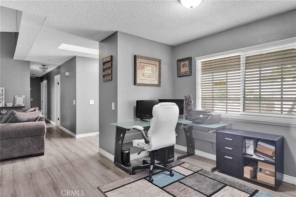 14111 Liberty Way Victorville, CA 92392 - Photo 11 of 39 a work room with furniture and wooden floor