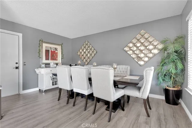 a kitchen with a refrigerator a sink dishwasher a stove and white cabinets with wooden floor