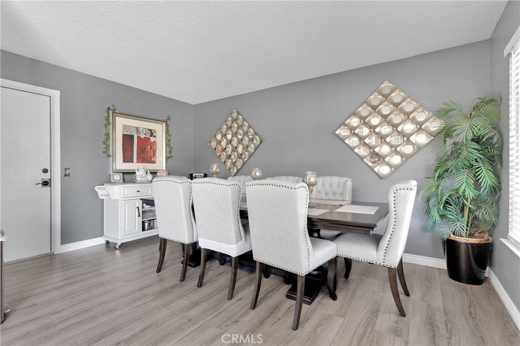 14111 Liberty Way Victorville, CA 92392 - Photo 12 of 39 a view of a dining room with furniture and wooden floor