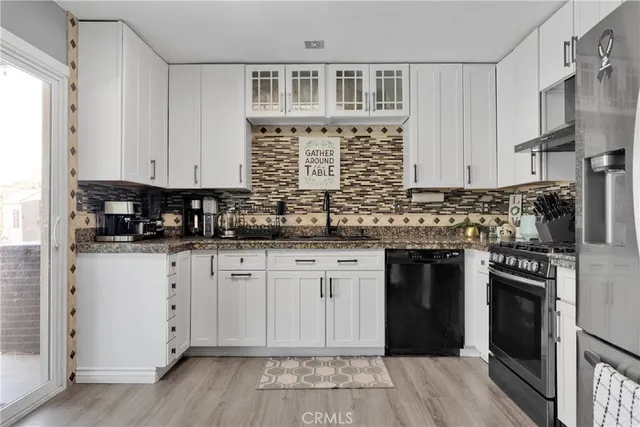 a kitchen with a refrigerator sink and stainless steel appliances