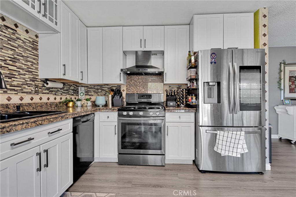 14111 Liberty Way Victorville, CA 92392 - Photo 15 of 39 a kitchen with a refrigerator sink and stainless steel appliances