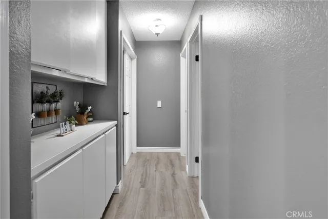 a bedroom with a bed and a flat tv screen on wall