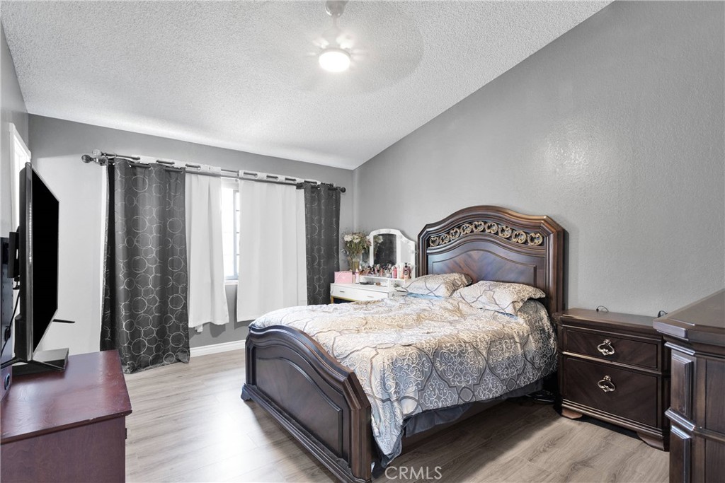 14111 Liberty Way Victorville, CA 92392 - Photo 18 of 39 a bedroom with a bed and a flat tv screen on a dresser