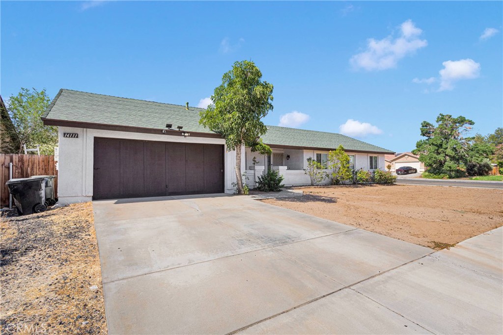 14111 Liberty Way Victorville, CA 92392 - Photo 2 of 39 a front view of a house with a yard and garage