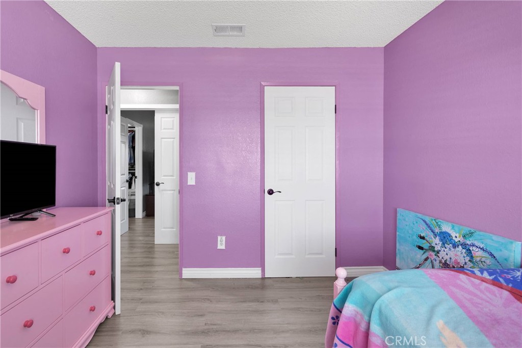 14111 Liberty Way Victorville, CA 92392 - Photo 22 of 39 a bedroom with a bed and a flat screen tv