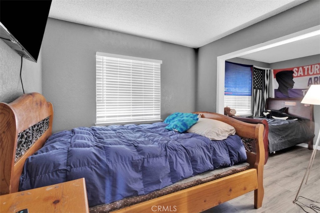 14111 Liberty Way Victorville, CA 92392 - Photo 23 of 39 a bedroom with a bed and window