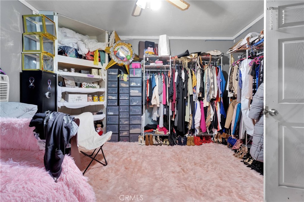 14111 Liberty Way Victorville, CA 92392 - Photo 27 of 39 a view of walk in closet with clothes