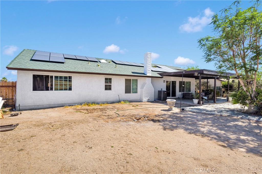 14111 Liberty Way Victorville, CA 92392 - Photo 30 of 39 a patio with a table and chairs under an umbrella