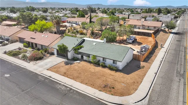 an aerial view of a house with a swimming pool