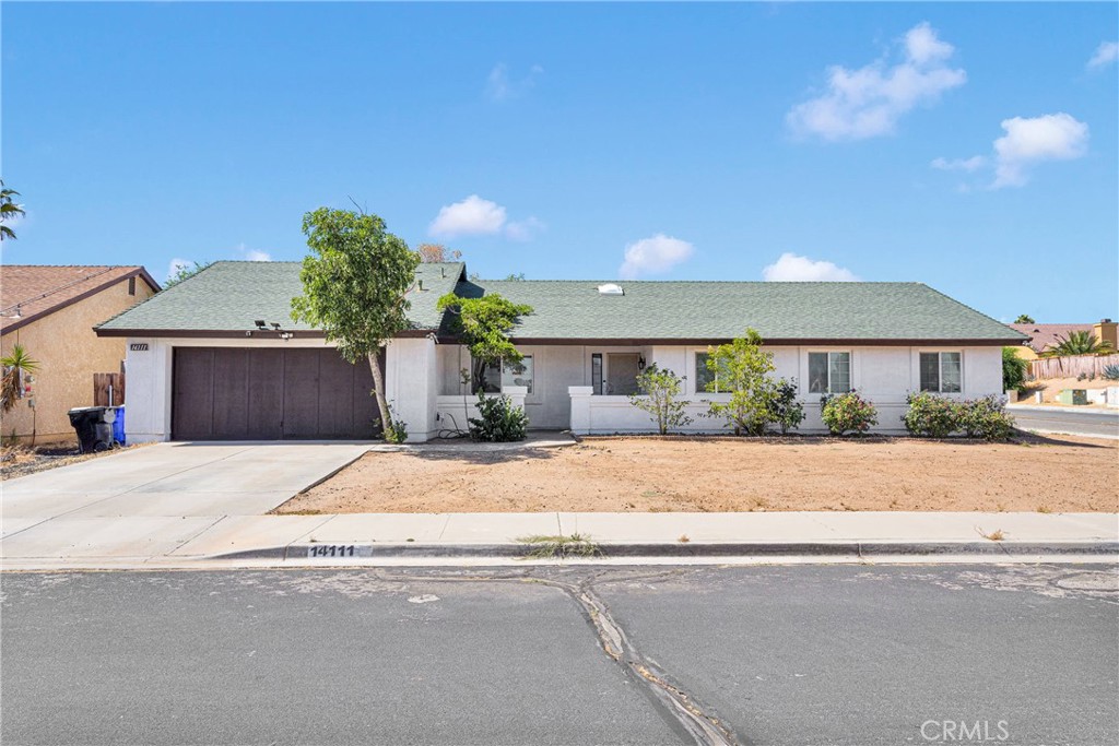 14111 Liberty Way Victorville, CA 92392 - Photo 4 of 39 a front view of a house with a yard and garage
