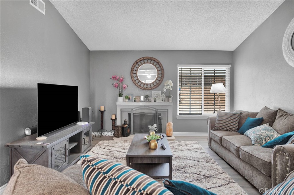 14111 Liberty Way Victorville, CA 92392 - Photo 7 of 39 a living room with furniture a fireplace and a flat screen tv