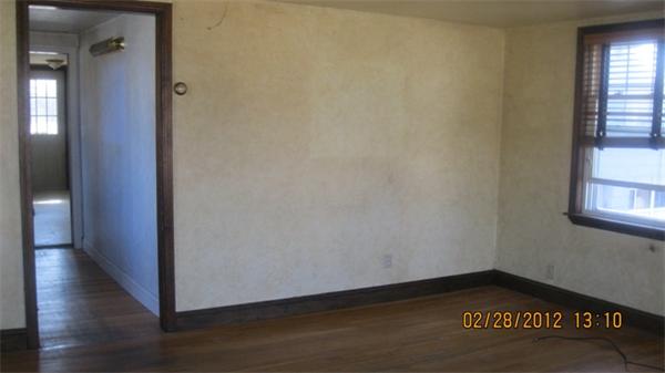 16 Plant Road Waltham, MA 02451 - Photo 16 of 18 a view of an empty room with wooden floor and a window