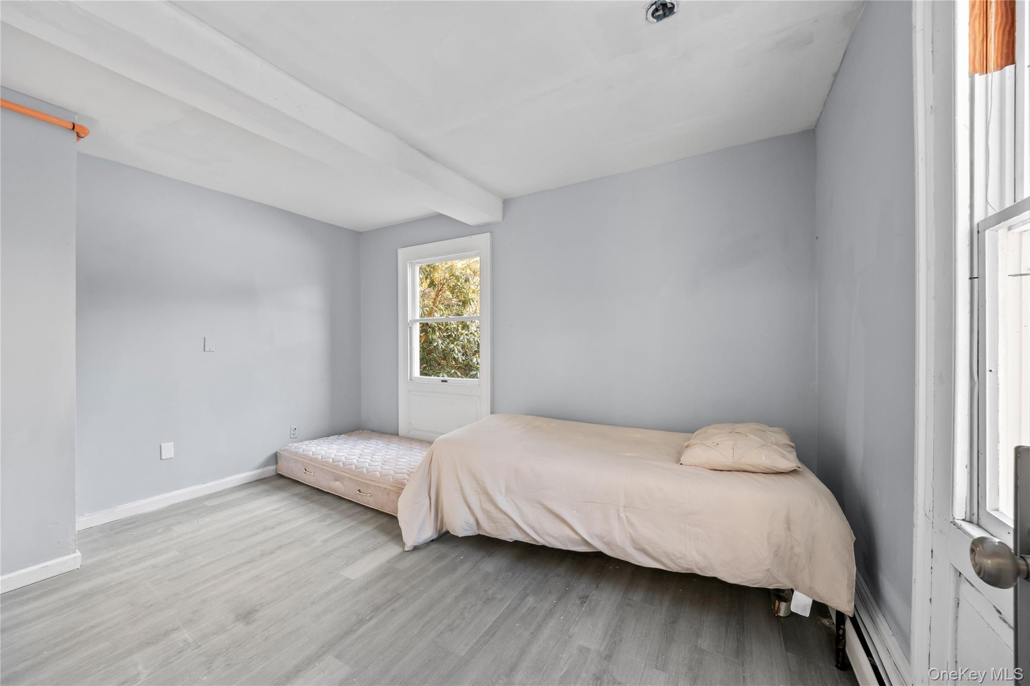 996 Haverstraw Road Suffern, NY 10901 - Photo 15 of 50 a bedroom with a bed and a window