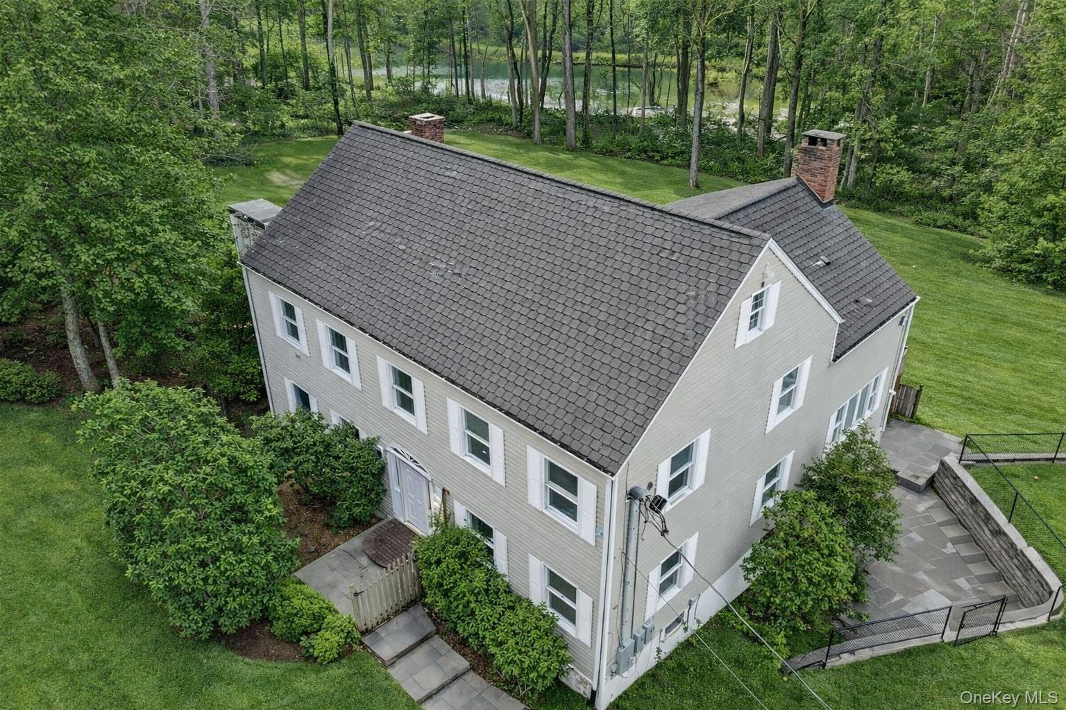 996 Haverstraw Road Suffern, NY 10901 - Photo 2 of 50 an aerial view of a house with a yard table and chairs