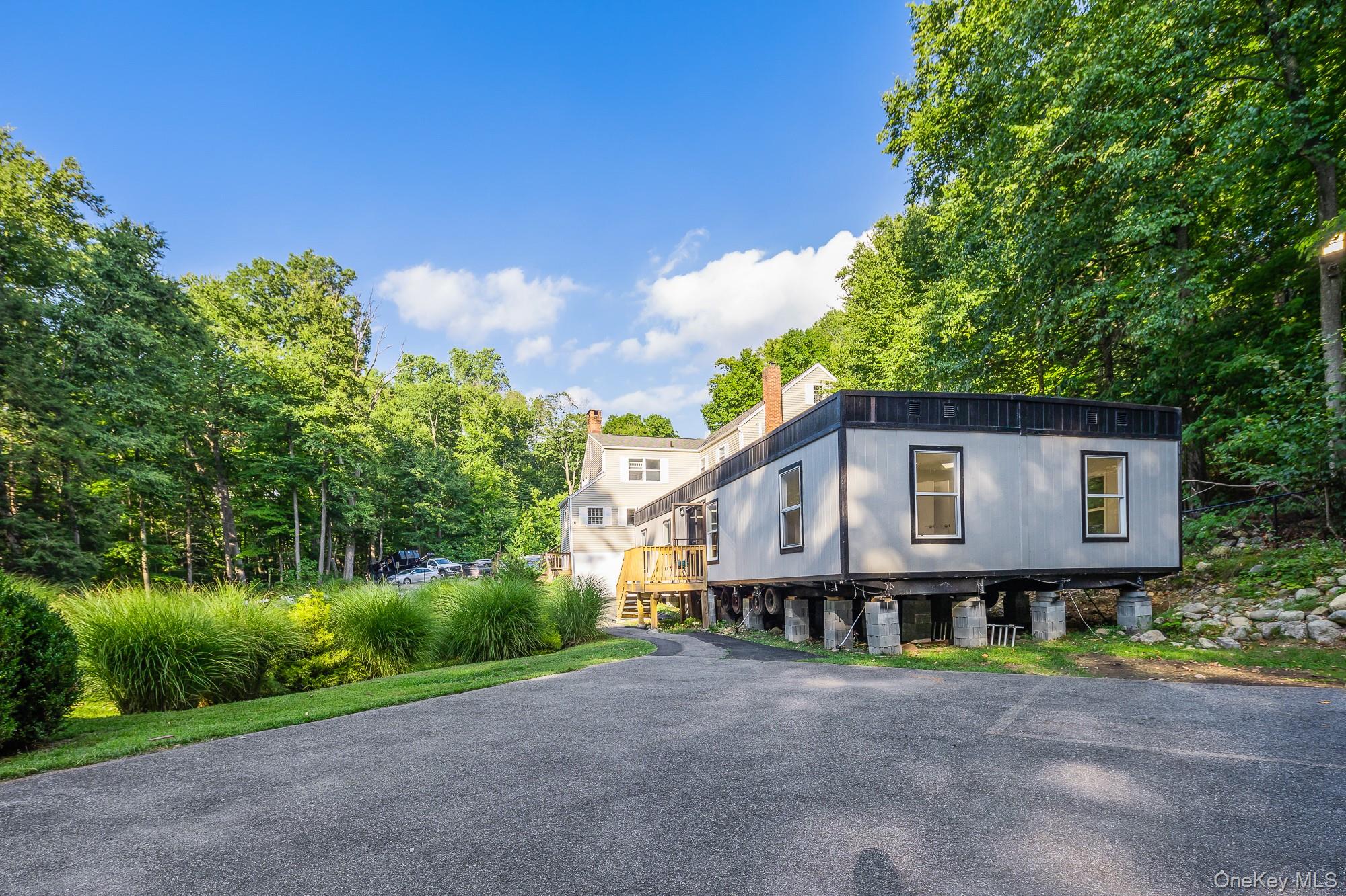 996 Haverstraw Road Suffern, NY 10901 - Photo 41 of 50 a house with trees in front of it