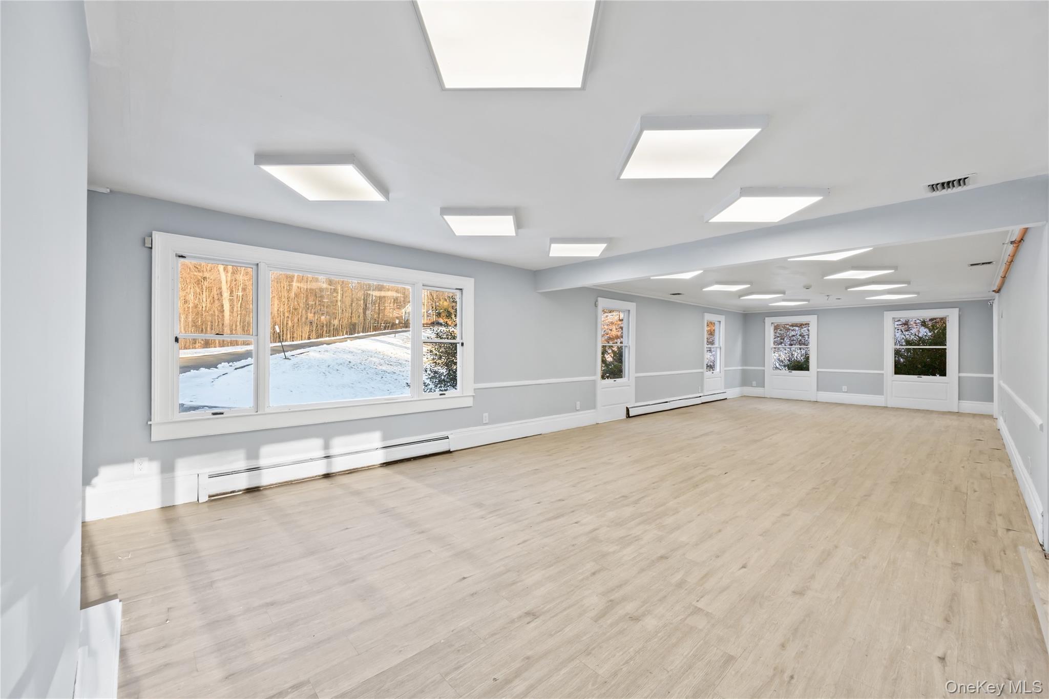 996 Haverstraw Road Suffern, NY 10901 - Photo 5 of 50 a view of an empty room with a window and wooden floor