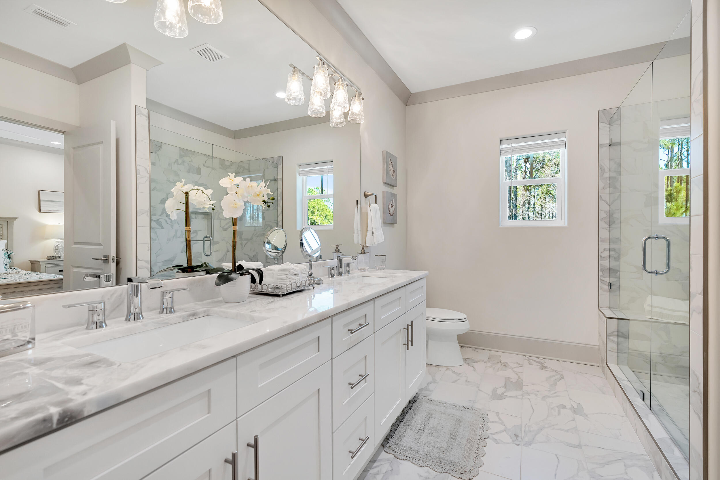 135 Golden Bell Ct Inlet Beach, Unit 135D Inlet Beach, FL 32461 - Photo 21 of 44 a spacious bathroom with a granite countertop sink a toilet and a mirror