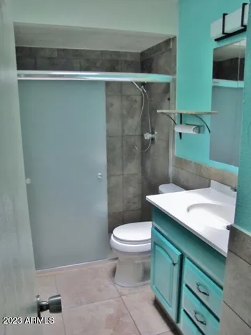 a bathroom with a toilet and a shower