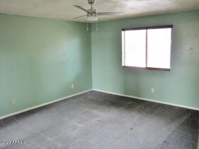 an empty room with closet and a bathroom