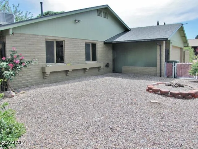 a view of a house with backyard and sitting area
