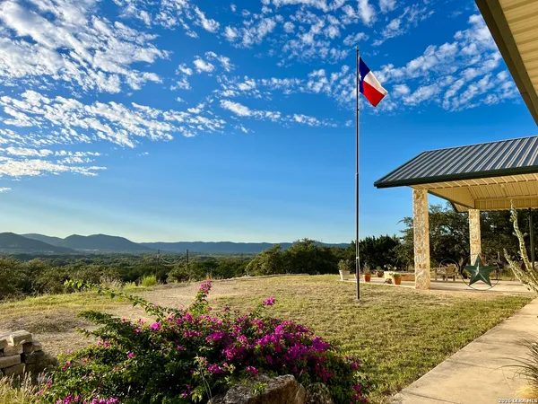 a view of a house with a yard and a sitting area
