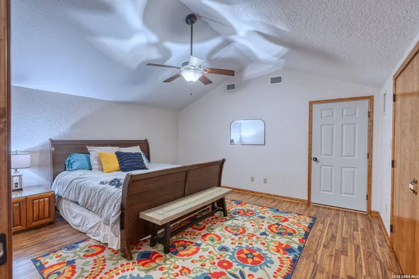 a bedroom with a bed and a painting on the wall