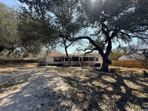 a large tree in front of a house
